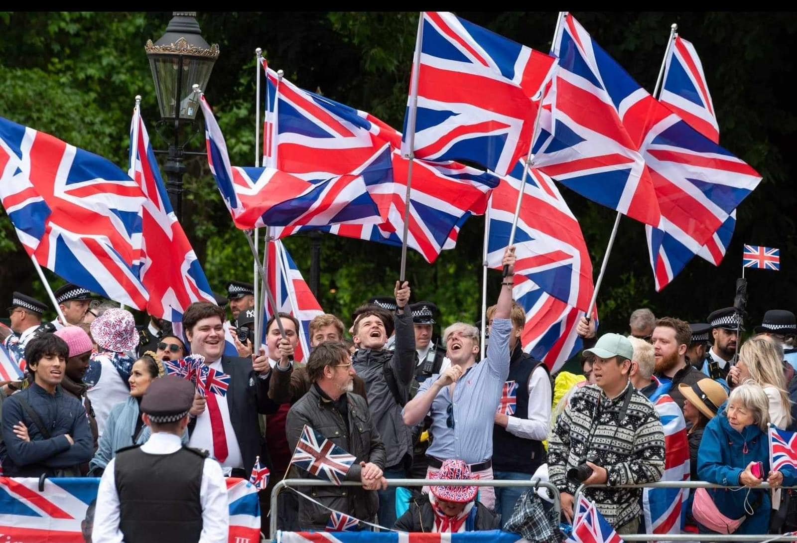Royalist supporters waving Union flags along the procession route during the British Royalist Society counter demonstration, 2024.